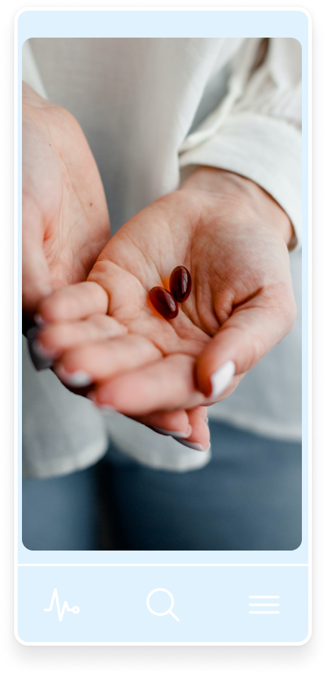A supplement tablet in someone's palm