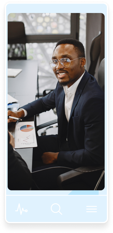 A man on black suit smiling at the camera