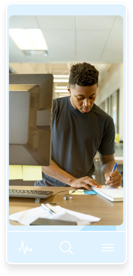 An aspiring doctor siting in front of a computer and studying